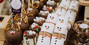 Baked goods and marshmallows with reindeer faces and snowmen