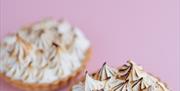 Image shows two minature lemon meringue pies