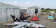 image is of various planes at the Ulster Aviation Society