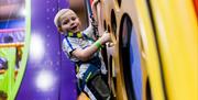 Little boy on Clip'n'Climb at High Rise Lisburn