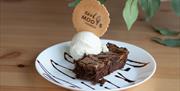 An image of a brownie with ice cream