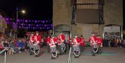 Local musicians preforming drum salute in uniform