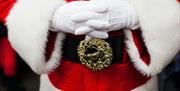 An image of Santa with his hands crossed over his stomach