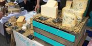 Image shows a selection of cheese at a stall