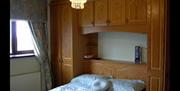 Image shows double bed with wardrobe