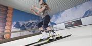 Image is of a girl on the indoor ski slope