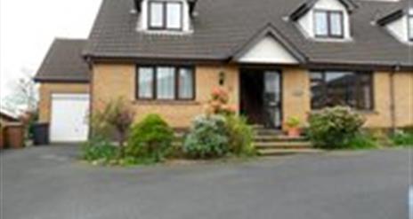 Image shows front of property with a few low steps and tarmac driveway