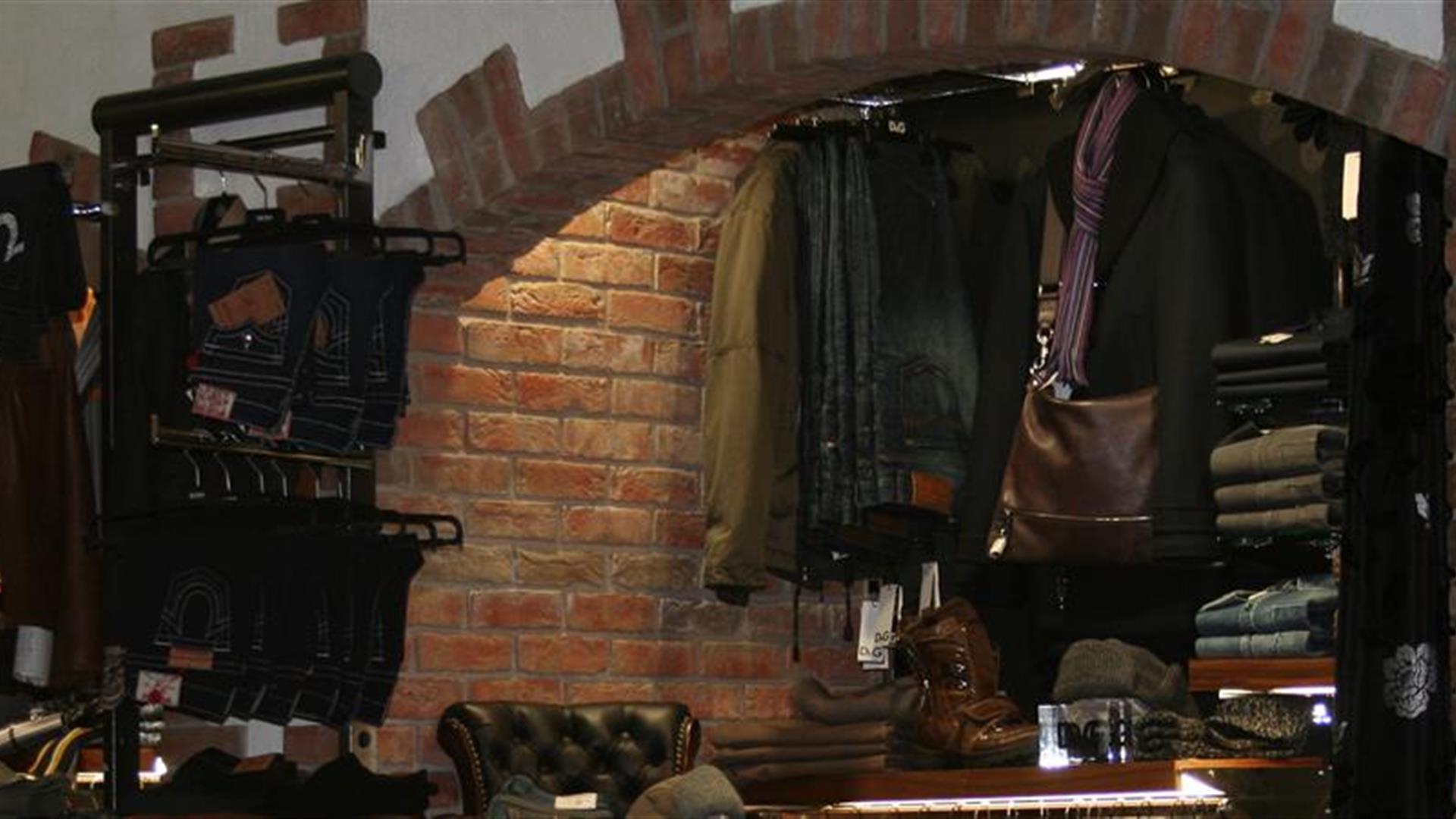 Image shows men's clothes for sale inside shop