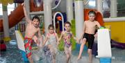 Image shows children splashing around in the swimming pool