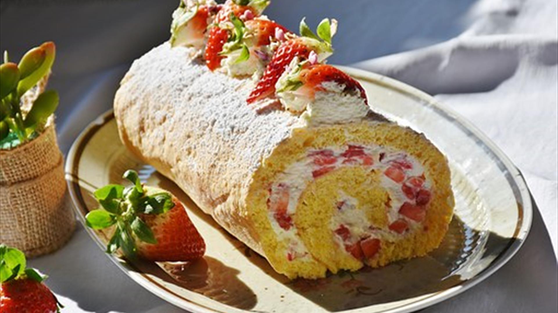 Image is of a strawberry and cake roll