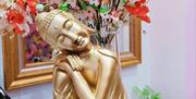 Image is of a gold Buddha statue in Spoil and Spa Lisburn