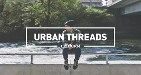 Image shows man sitting on a ledge with a river behind him and the words Urban Threads Lisburn written across the image