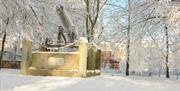 Image is of a cannon in Castle Gardens during a snowfall