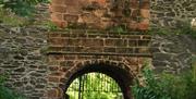 Image is of archway and gate in Castle Gardens