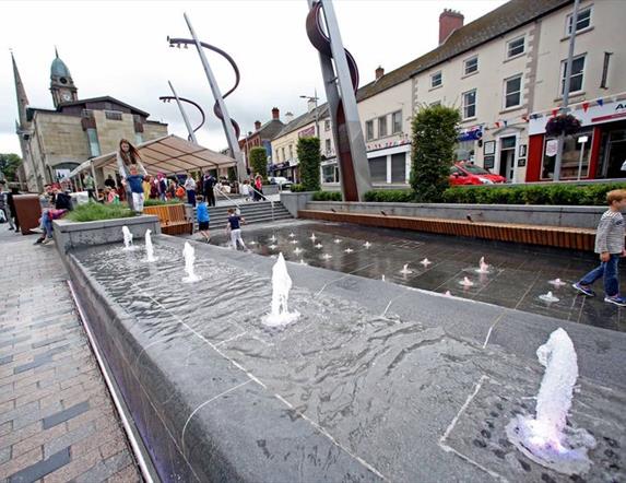 The fountains in Market Square with the Irish Linen Centre & Lisburn Museum in the background