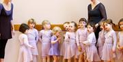 Clare Novaes Ballet school. Ballet teachers with young girls in ballet outfits.