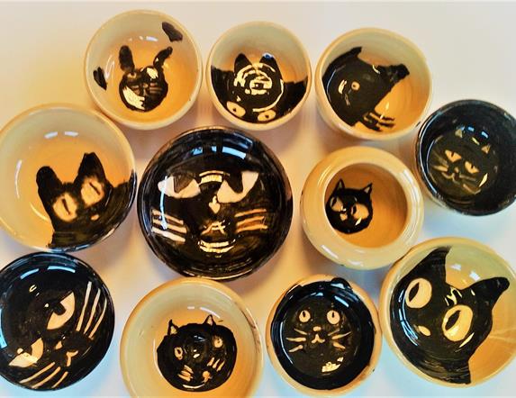 Image is of cat themed clay objects