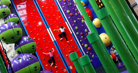 An image with two climbers on the climbing walls