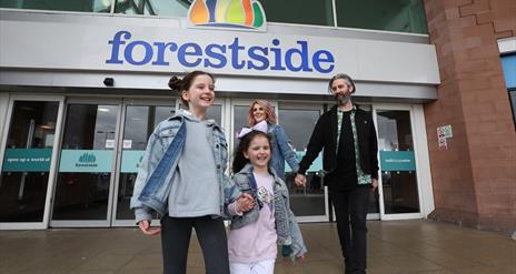 An image of a family leaving the shopping centre at Forestside
