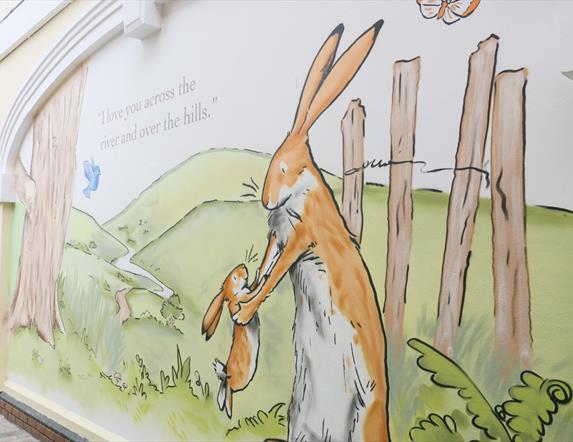 Picture is of murals of little nutbrown hare and big nutbrown hair in Haslem's Lane, Lisburn