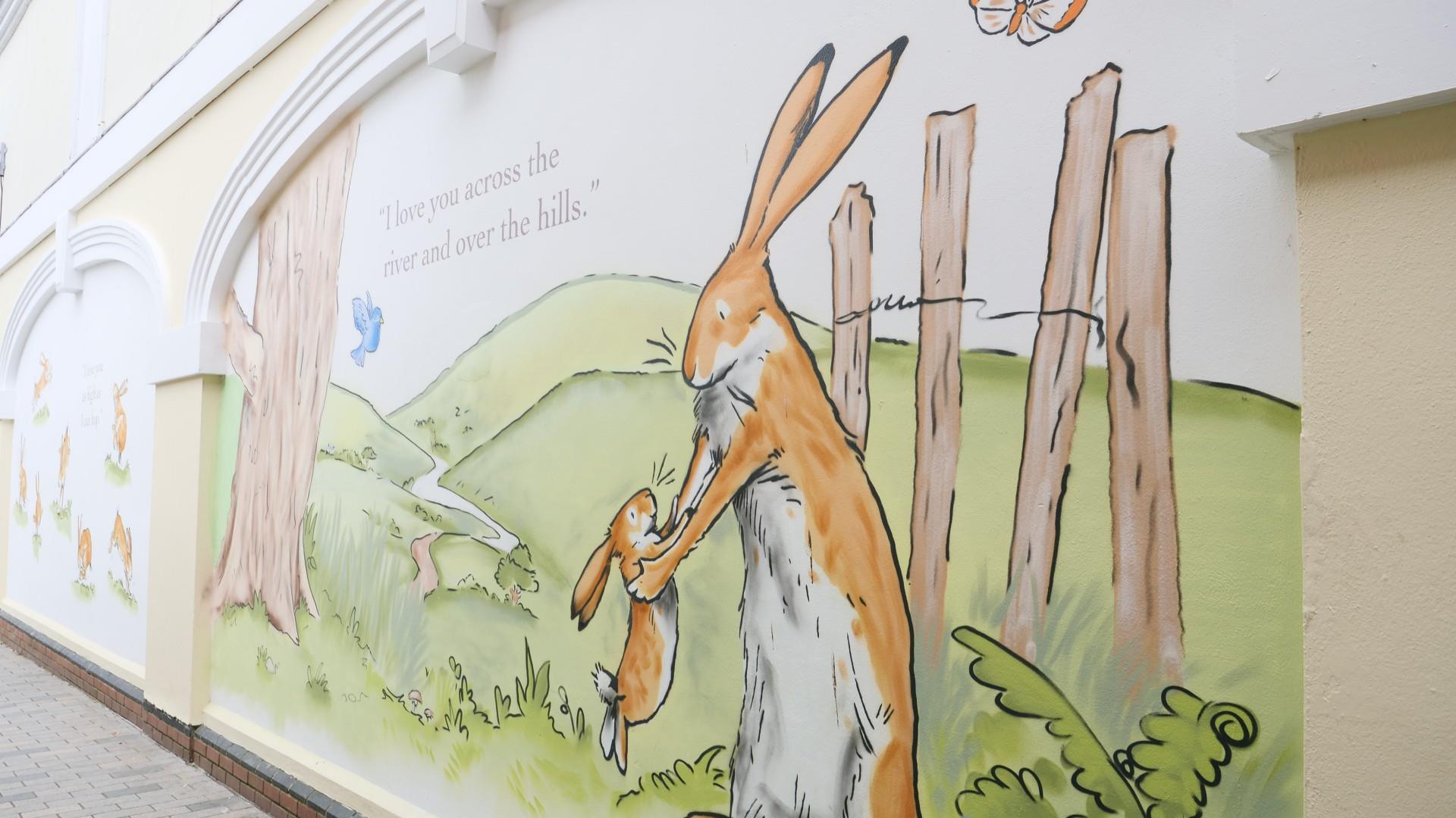 Picture is of murals of little nutbrown hare and big nutbrown hair in Haslem's Lane, Lisburn