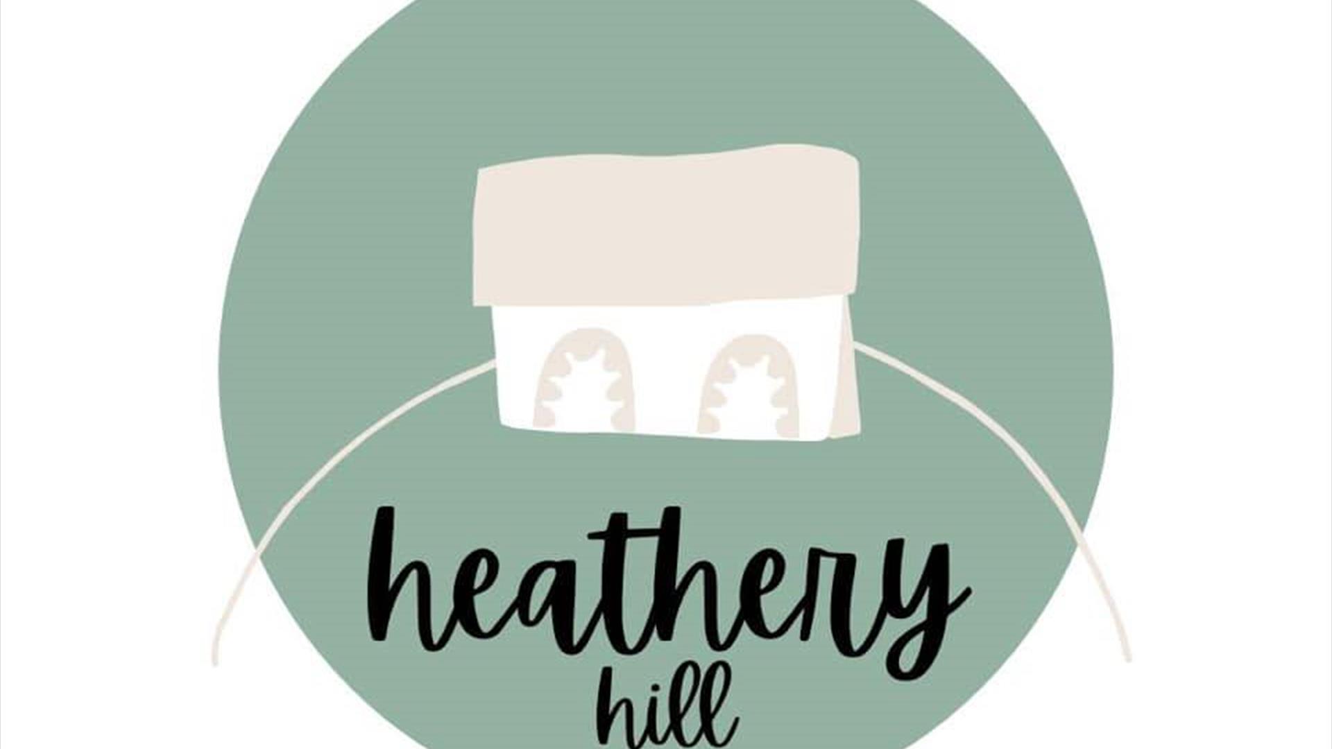 Images shows logo of heathery hill which is a small house within a green circle