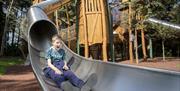 Child on slide at play park