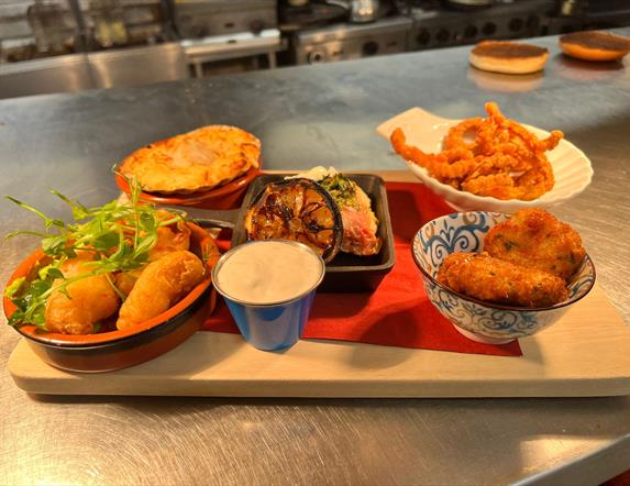An image of a selection of food on a serving board that can be ordered at the Speckled hen