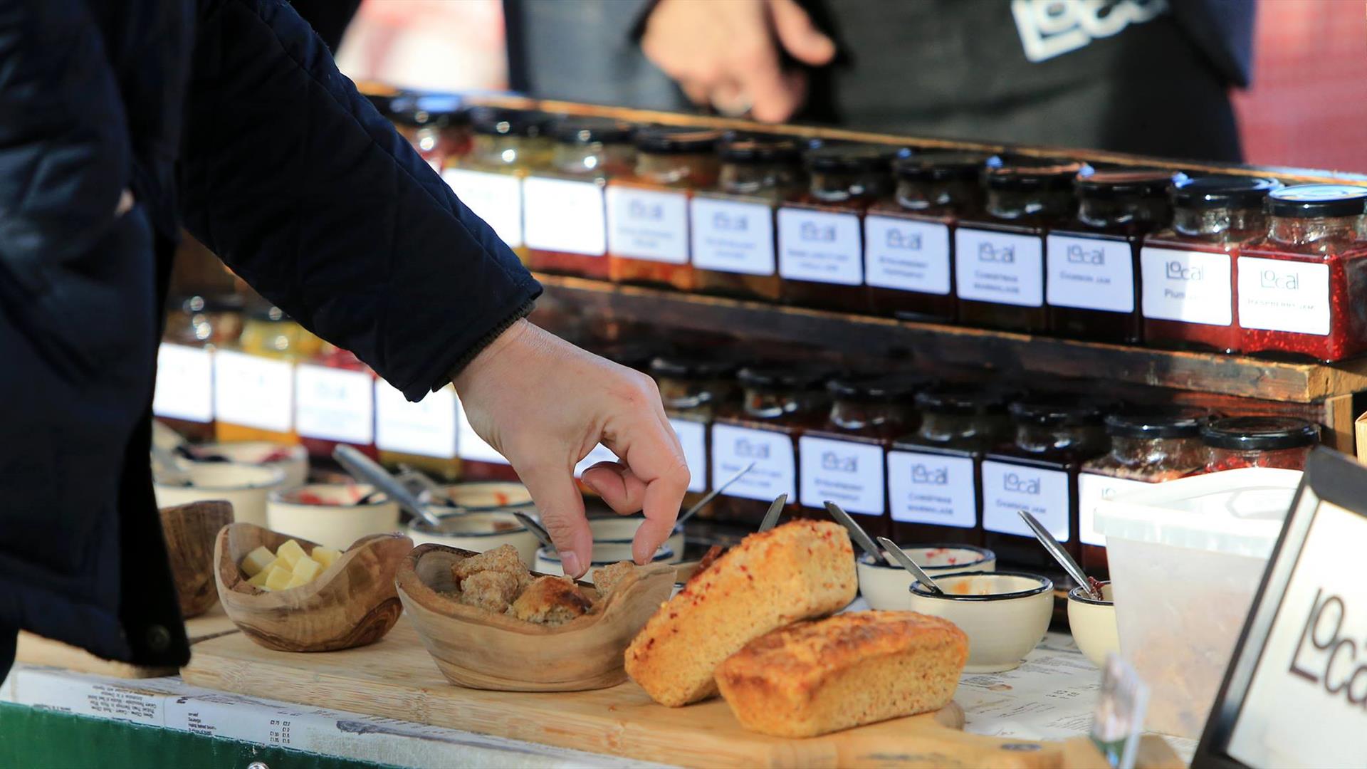 Image is of a bread and relish stand at the market