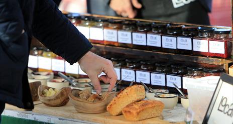 Image is of a bread and relish stand at the market