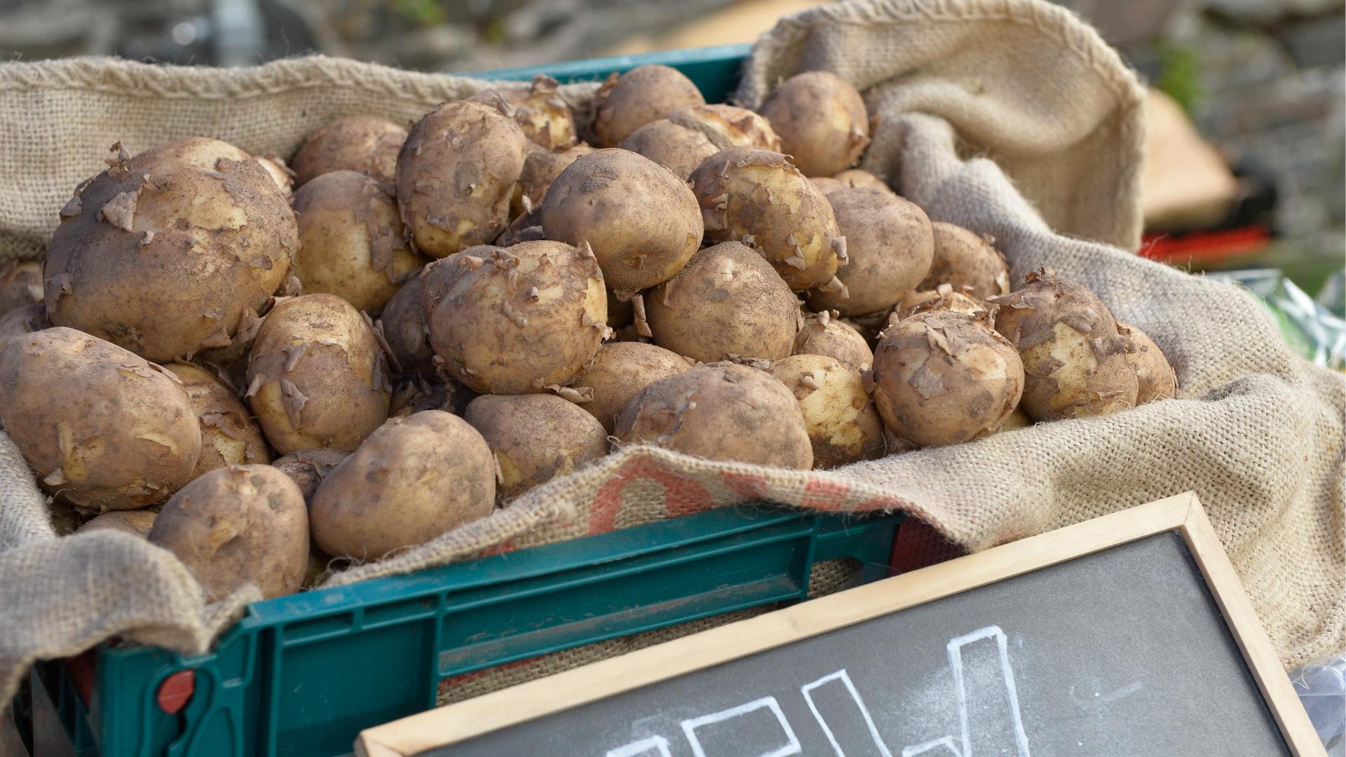 Image shows a potato stall at the market