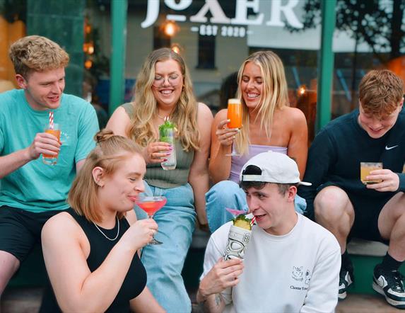 Joxer team sitting outside their restaurant drinking cocktails