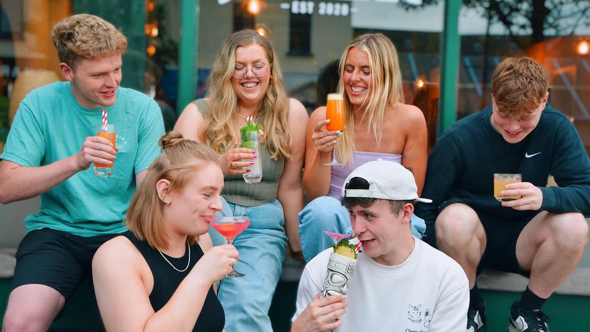 Joxer team sitting outside their restaurant drinking cocktails