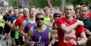 Image is of various runners taking part in the Lisburn Half Marathon