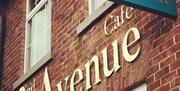 Image shows front of 2nd Avenue Cafe with named sign