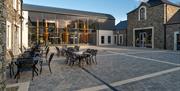 Courtyard at Hinch Distillery with outdoor seating and tables