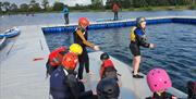 A group of children getting ready to do watersports