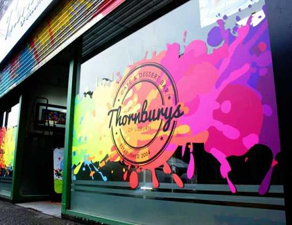 Brightly coloured image with mix of colours and logo sign of Thornbury's cafe Lisburn