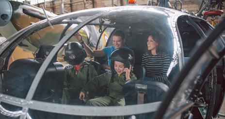 Family in cock pit of helicopter