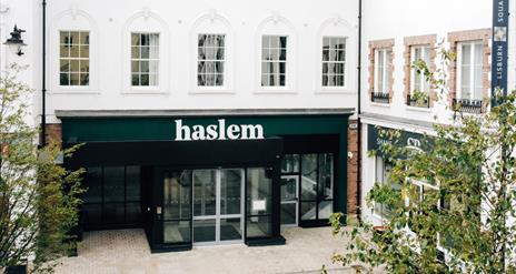 Shot of exterior of Haslem Hotel in corner Lisburn Square with trees to either side
