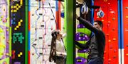 Young Girl and Dad on Face to Face Climbing Wall