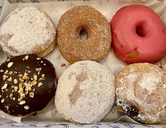 Image shows a box of 6 different donuts