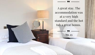 An image of a guest review from Larchfield Estate with twin beds in the background of the image.